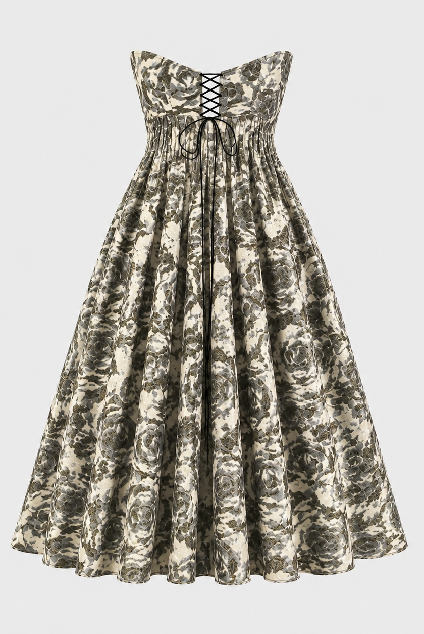 The Tala Corset Midi Dress by Sarvin is a strapless, ankle-length dress with a black and white floral pattern, featuring a fitted bodice with black lace-up front detail and a full gathered skirt for an elegant hourglass silhouette.