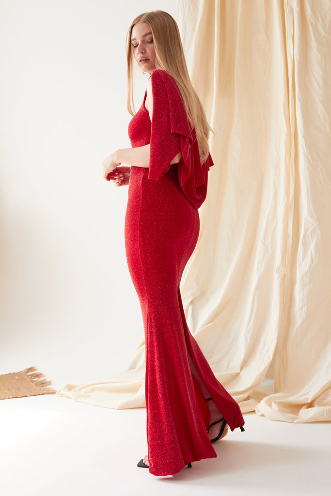A woman in a Sarvin Red Cowl Back Gown posing for a photo.