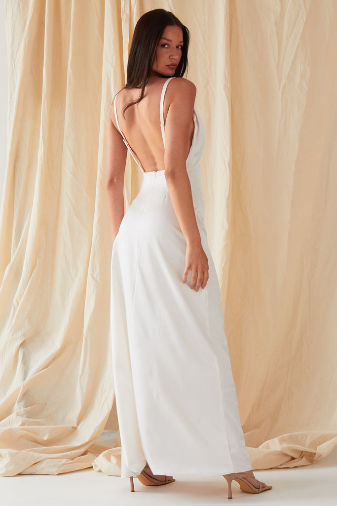 The back of a woman wearing the Sarvin Asymmetric White Maxi Dress.