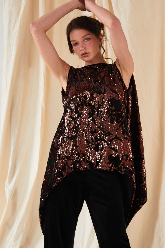 a model wearing a sequin top and Sarvin Wide Leg Velvet Trousers.