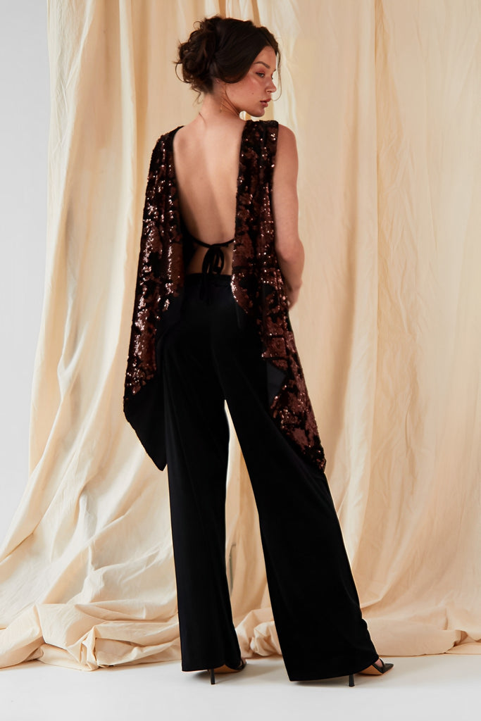the back view of a woman wearing Sarvin's Wide Leg Velvet Trousers.