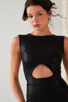 A woman wears the Sarvin Black Cut-Out Maxi Dress, featuring a sparkly sleeveless design, as she poses before a light backdrop. Her dark hair is styled loosely and she faces the camera directly.