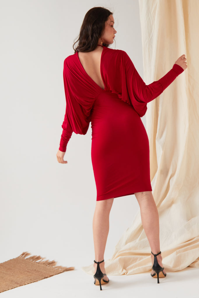 the back of a woman in a Sarvin Red Batwing Dress.