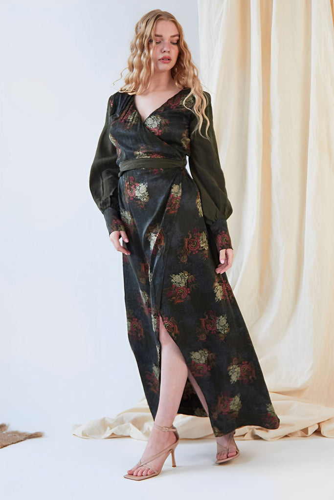 a woman wearing a black and green floral print Sarvin Long Sleeve Wrap Dress.