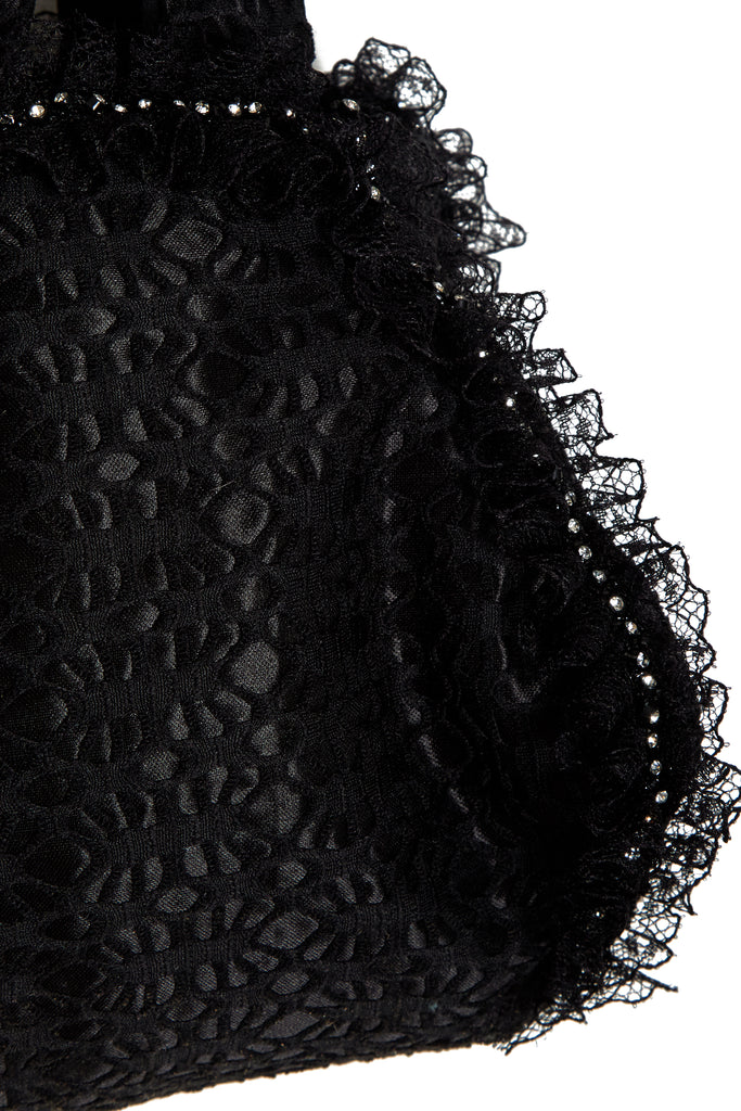 close up of Sarvin black lace pouch bag with trimmed lace