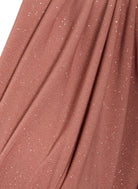 Close-up of the Sarvin Rose Gold Twist Knot Front Dress, featuring dusty rose pink fabric with fine silver glitter and a soft texture—ideal for creating an elegant, shimmering rose gold evening look.
