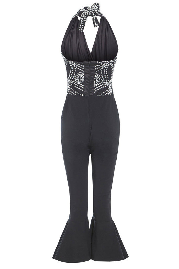 a Black Backless Jumpsuit by Sarvin with a halter neck.