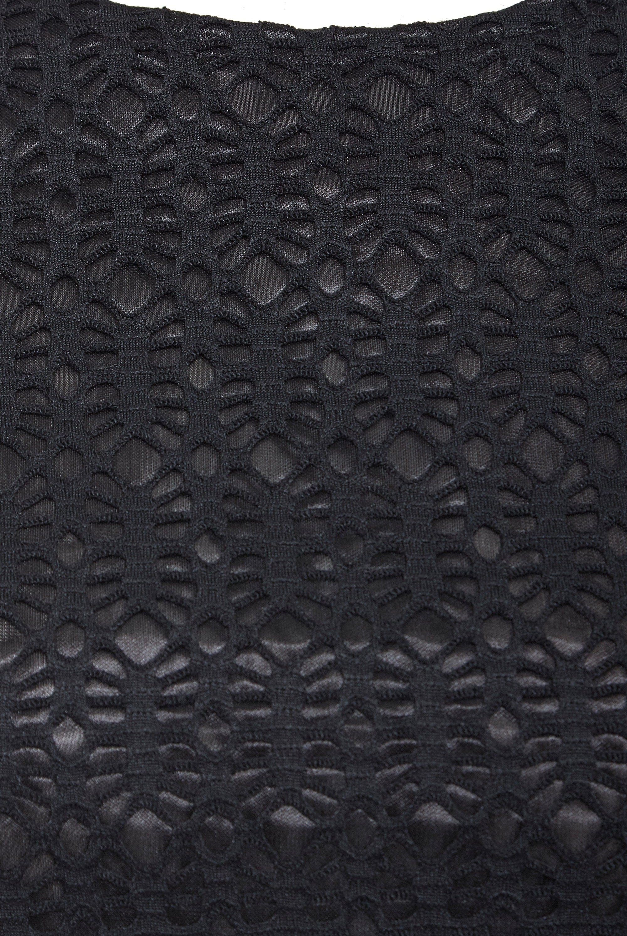 Close-up of the Black Twisted Backless Dress by Sarvin, highlighting its geometric black lace with open and solid sections for a textured, intricate look. The semi-sheer lace adds depth, making it ideal for a standout style.