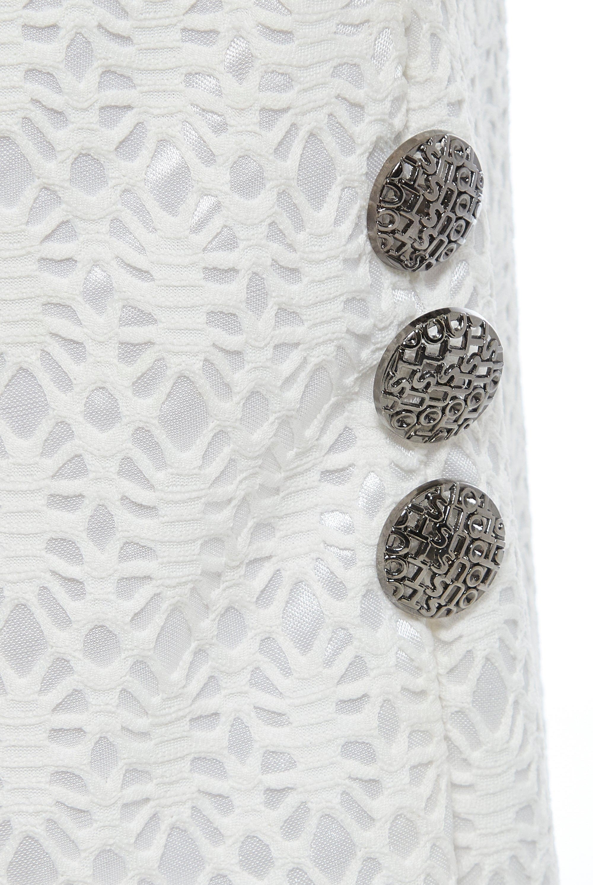 Close-up of Sarvin's White Bodycon Lace Skirt, handmade in the UK with a high waist, featuring three textured silver buttons on the right over floral lace and a shiny white lining.