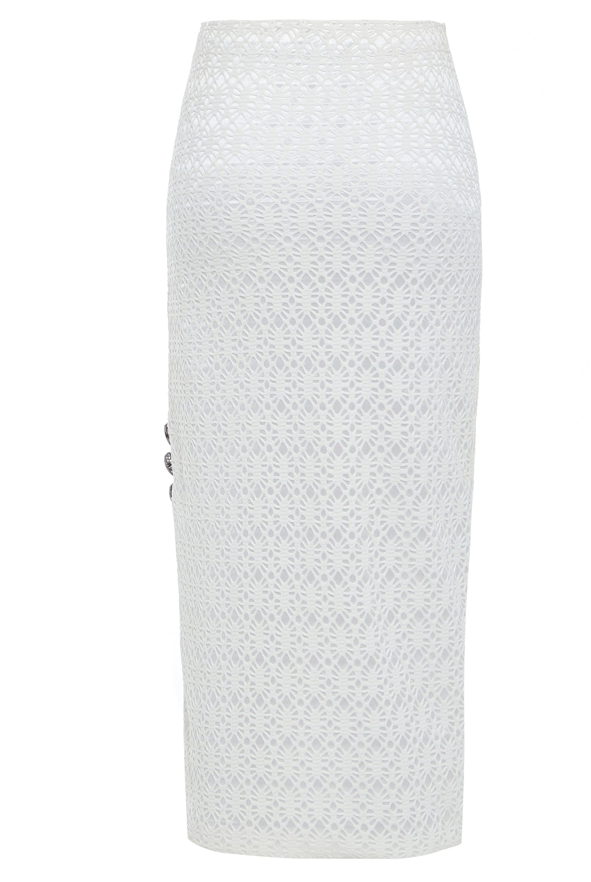 The Sarvin White Bodycon Lace Skirt is handmade in the UK with a knee-length, high-waisted pencil fit, featuring an intricate circular lace overlay and decorative side buttons for a chic finish.