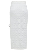 The Sarvin White Bodycon Lace Skirt is handmade in the UK with a knee-length, high-waisted pencil fit, featuring an intricate circular lace overlay and decorative side buttons for a chic finish.