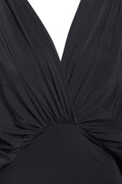 Close-up of the Sarvin Black Batwing Sleeve Midi Dress, featuring a deep V-neckline, gathered draped silk-touch jersey fabric, and a fitted waistband.