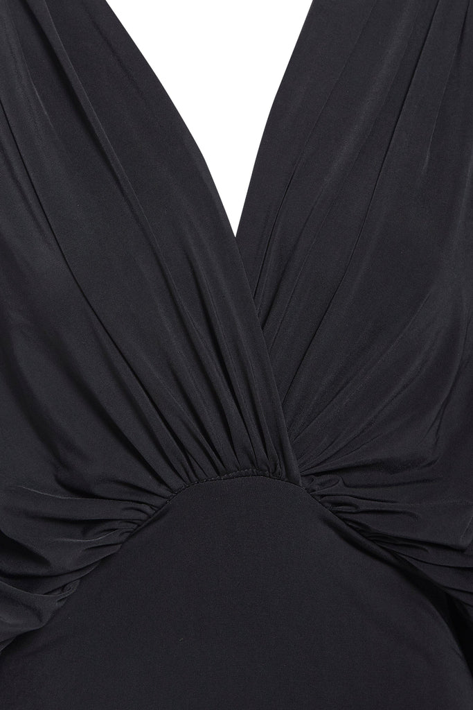 A close up of a Sarvin Black Batwing Sleeve Dress with a v neck.