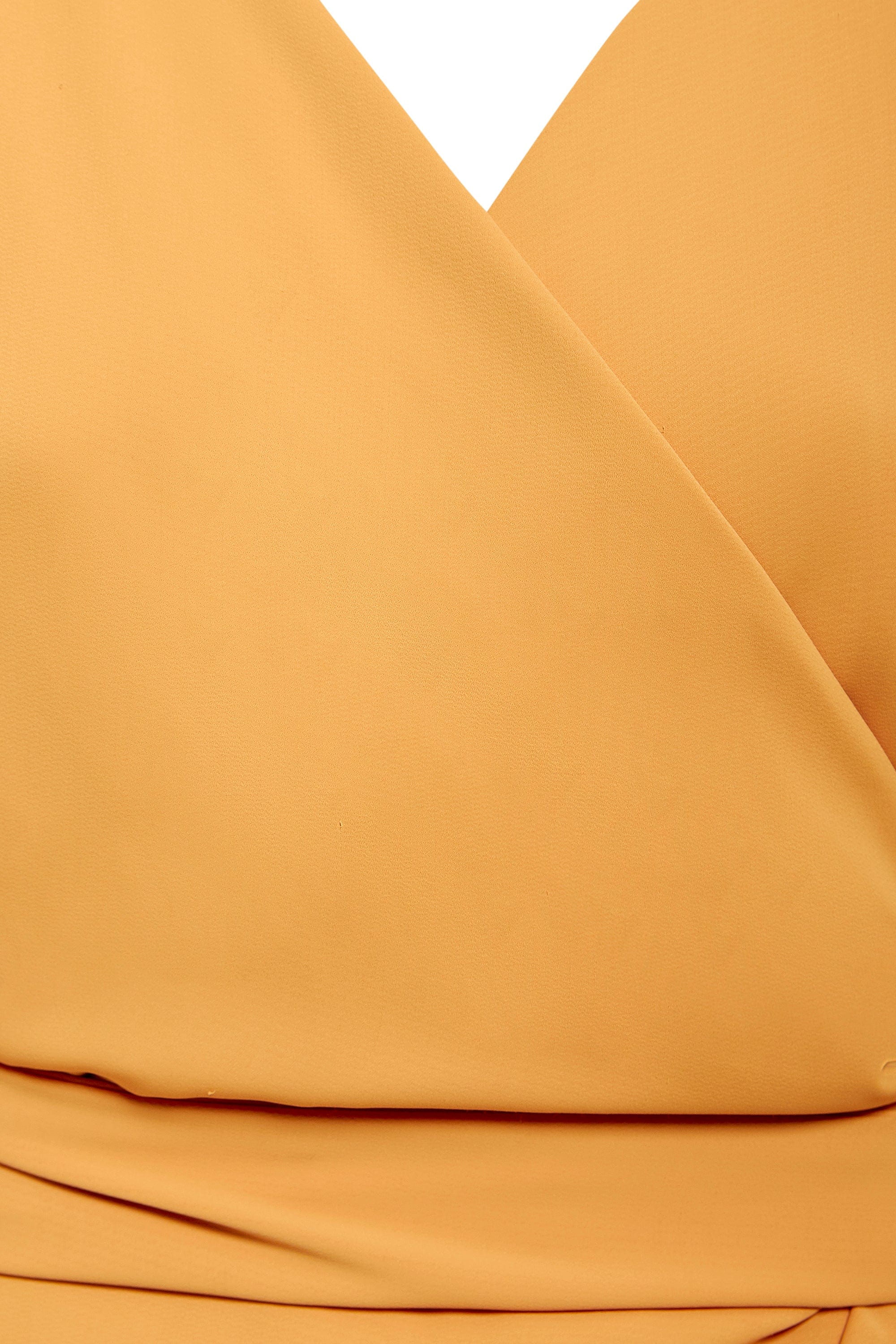 Close-up of the Sarvin Mustard Wrap Maxi Dress, showcasing a V-neckline and overlapping fabric with elegant waist folds.