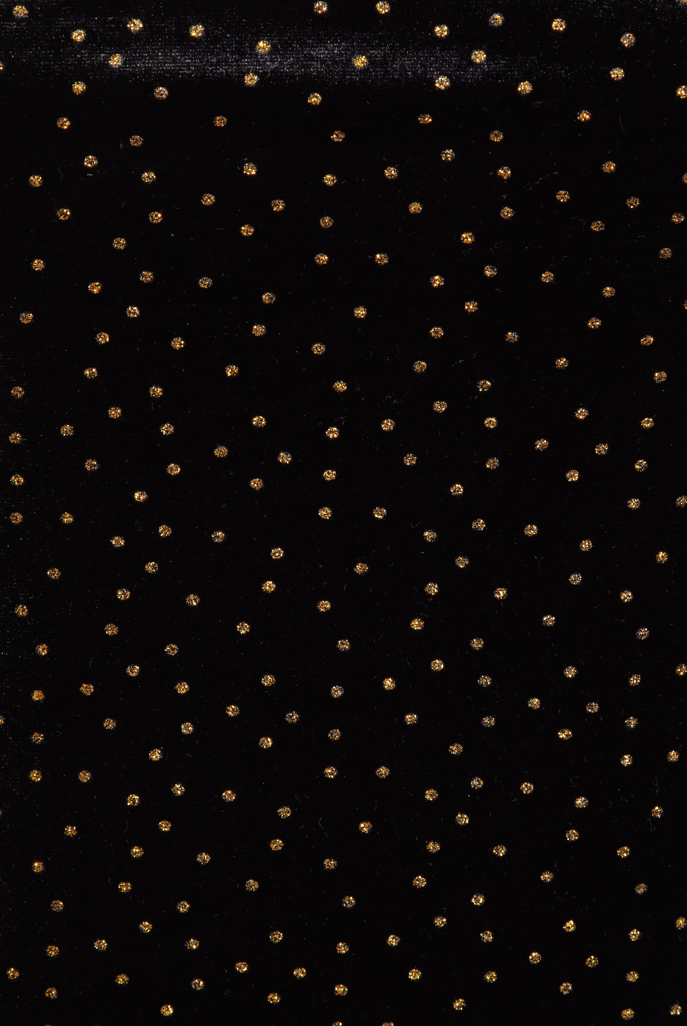 Inspired by Sarvin's Black Polka Dot Dress, this black background with evenly spaced gold dots echoes chic polka dot style—ideal for creating a stunning wedding guest dress.