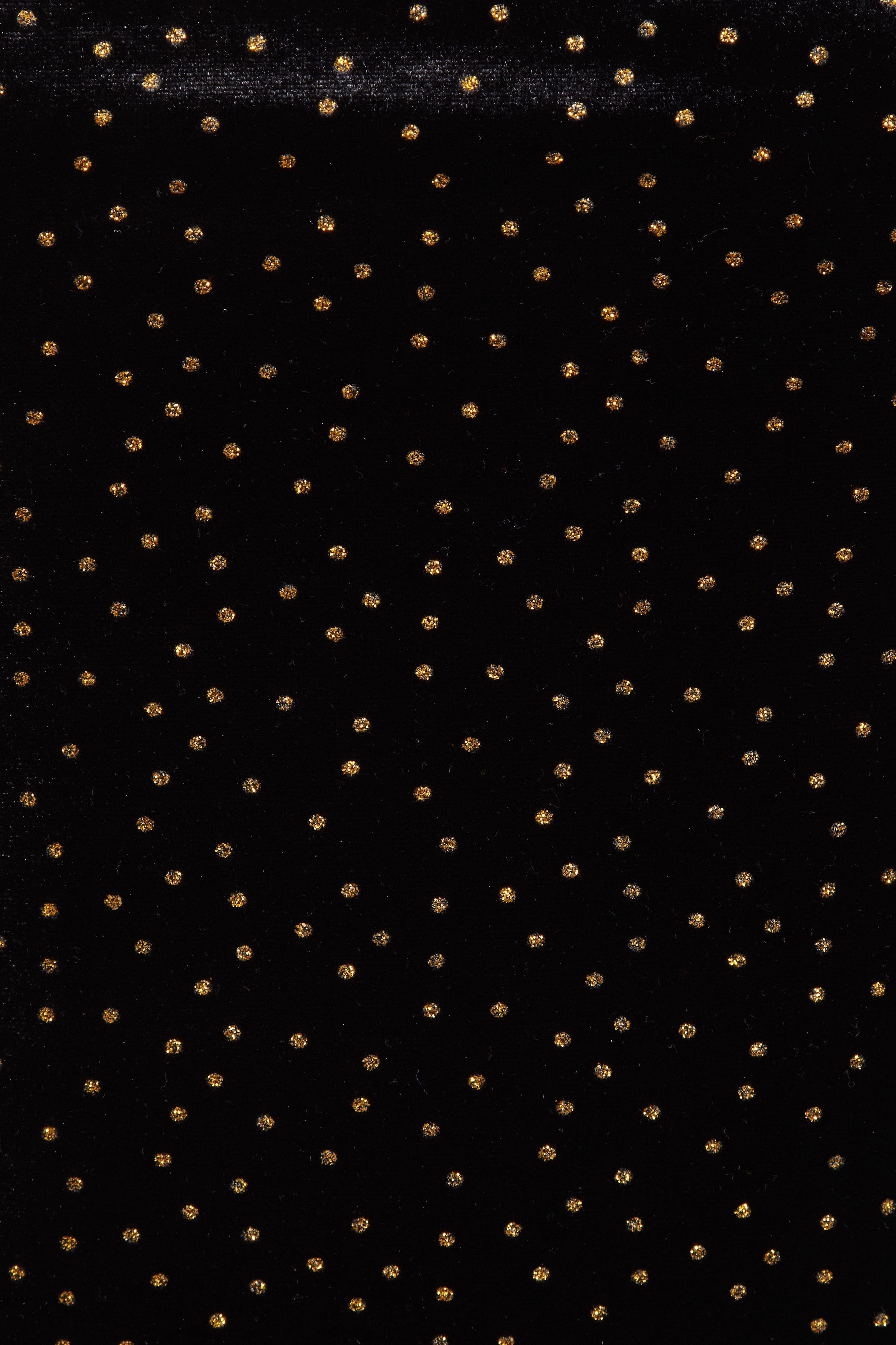 Inspired by Sarvin's Black Polka Dot Dress, this black background with evenly spaced gold dots echoes chic polka dot style—ideal for creating a stunning wedding guest dress.