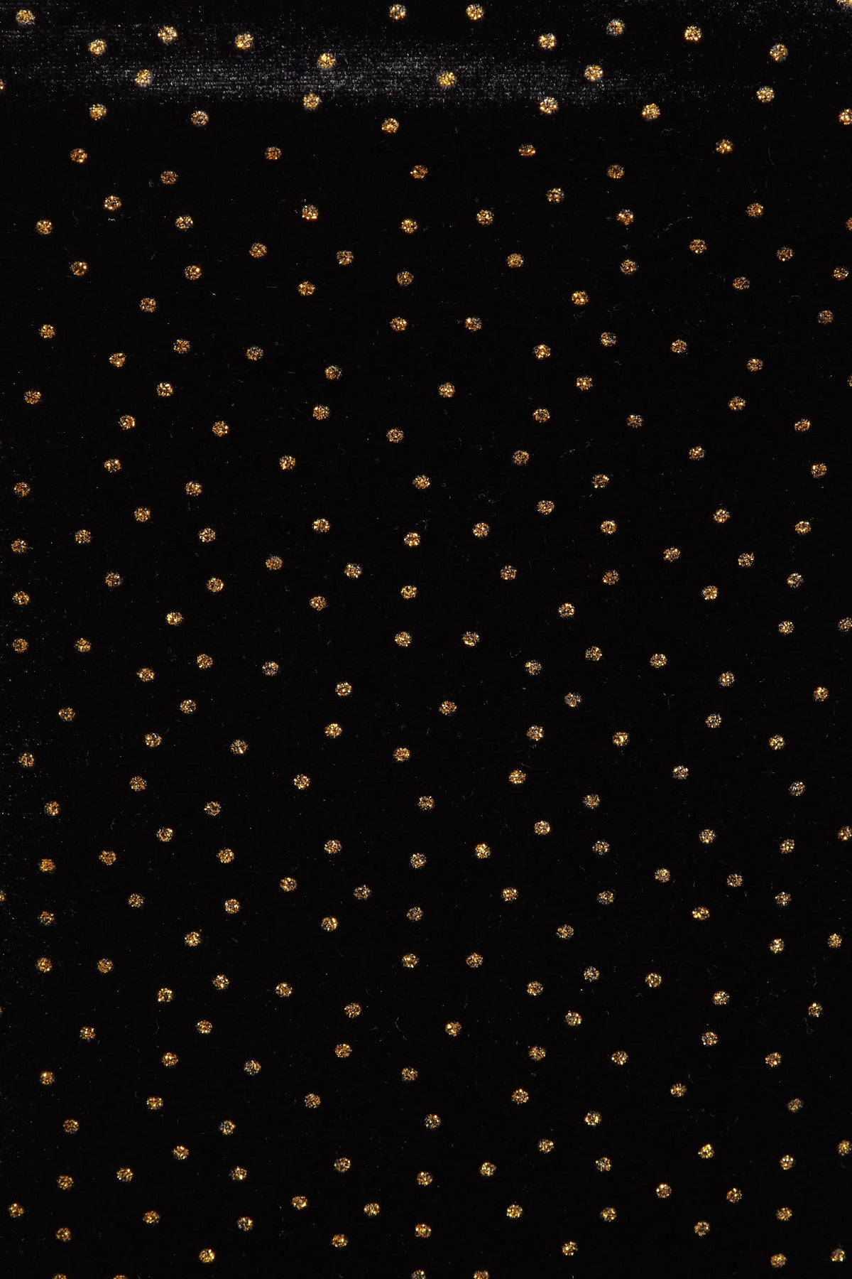 Inspired by Sarvin's Black Polka Dot Dress, this black background with evenly spaced gold dots echoes chic polka dot style—ideal for creating a stunning wedding guest dress.