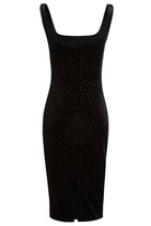 The Black Polka Dot Dress by Sarvin is a sleeveless, knee-length velvet dress featuring a square neckline, polka dots, and a small front hem vent—an elegant pick for any wedding guest.