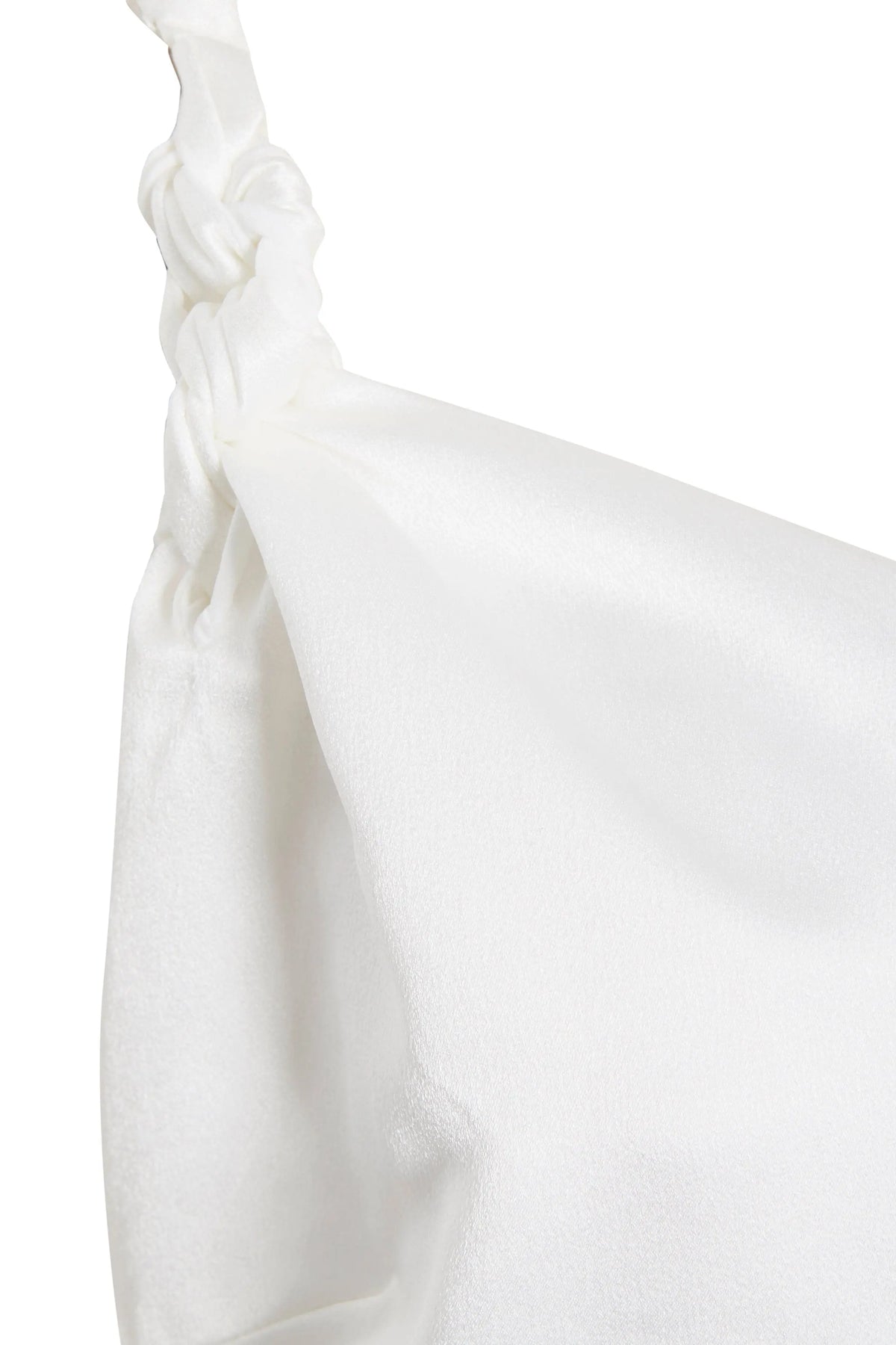 A close-up of smooth white satin with a knotted detail highlights the elegant texture of Sarvin's Ivory Satin Asymmetric Backless Maxi Dress.