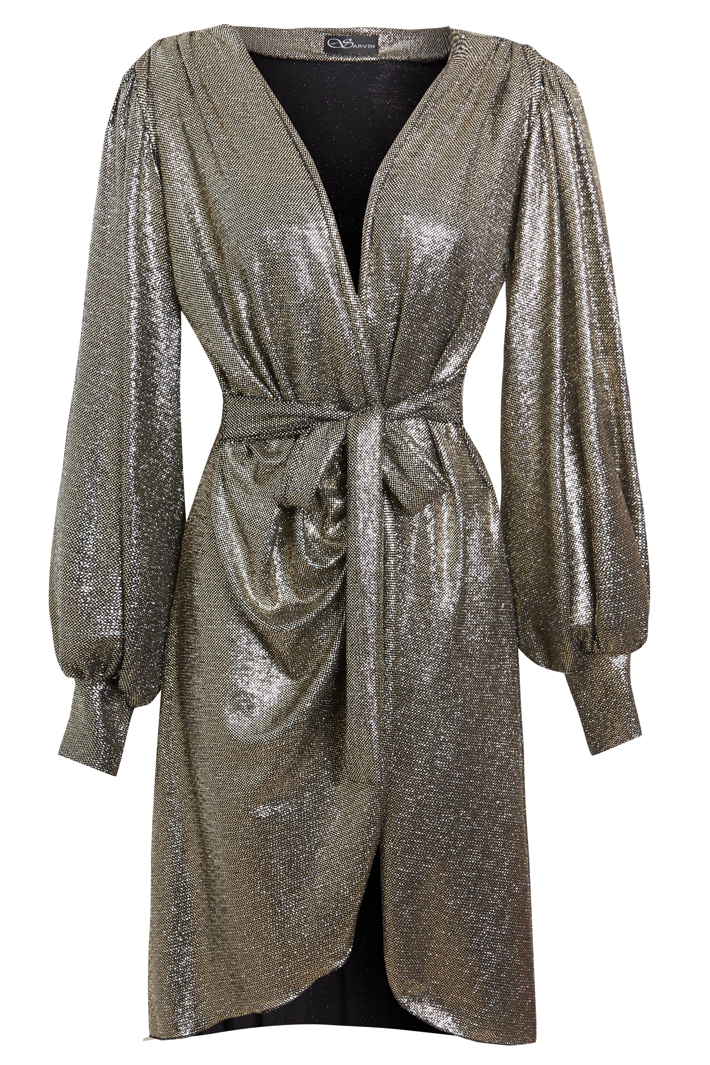 The Sarvin Long Sleeve Sequin Wrap Dress is a knee-length metallic silver evening dress featuring a deep V-neck, gathered waist with matching belt, draped front, subtle puffed sleeves, and shimmering textured fabric for a radiant look.