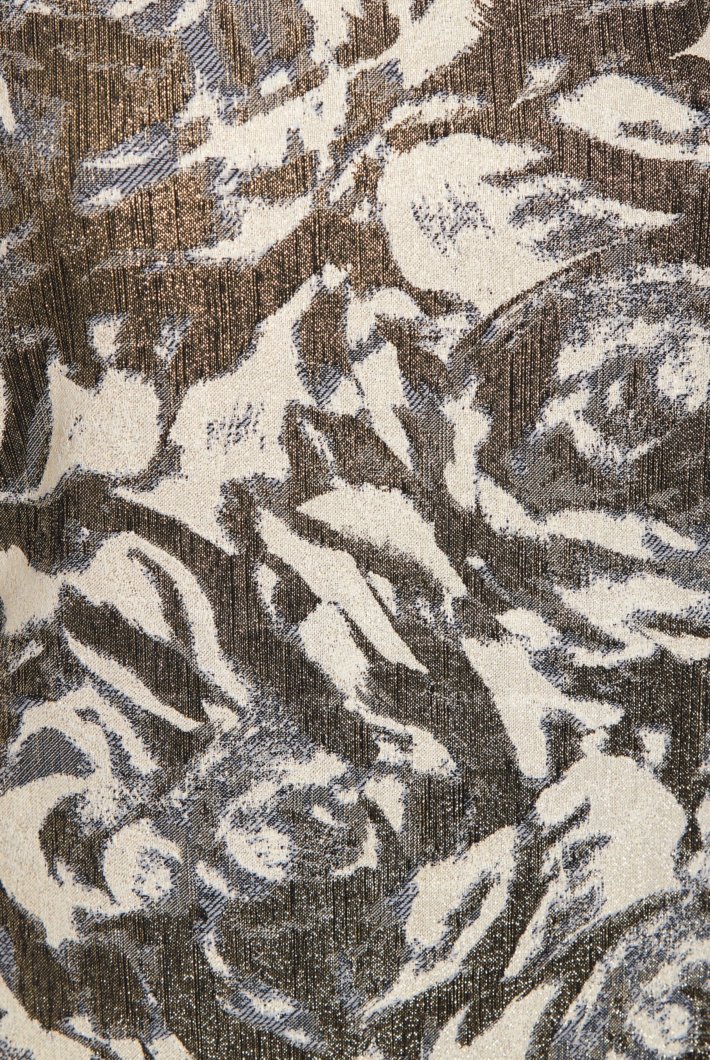 A close-up of Sarvin's Puff Shoulder Mini Dress shows its textured golden floral jacquard fabric with an abstract cream, brown, and gray pattern, slight sheen, and visible woven threads.