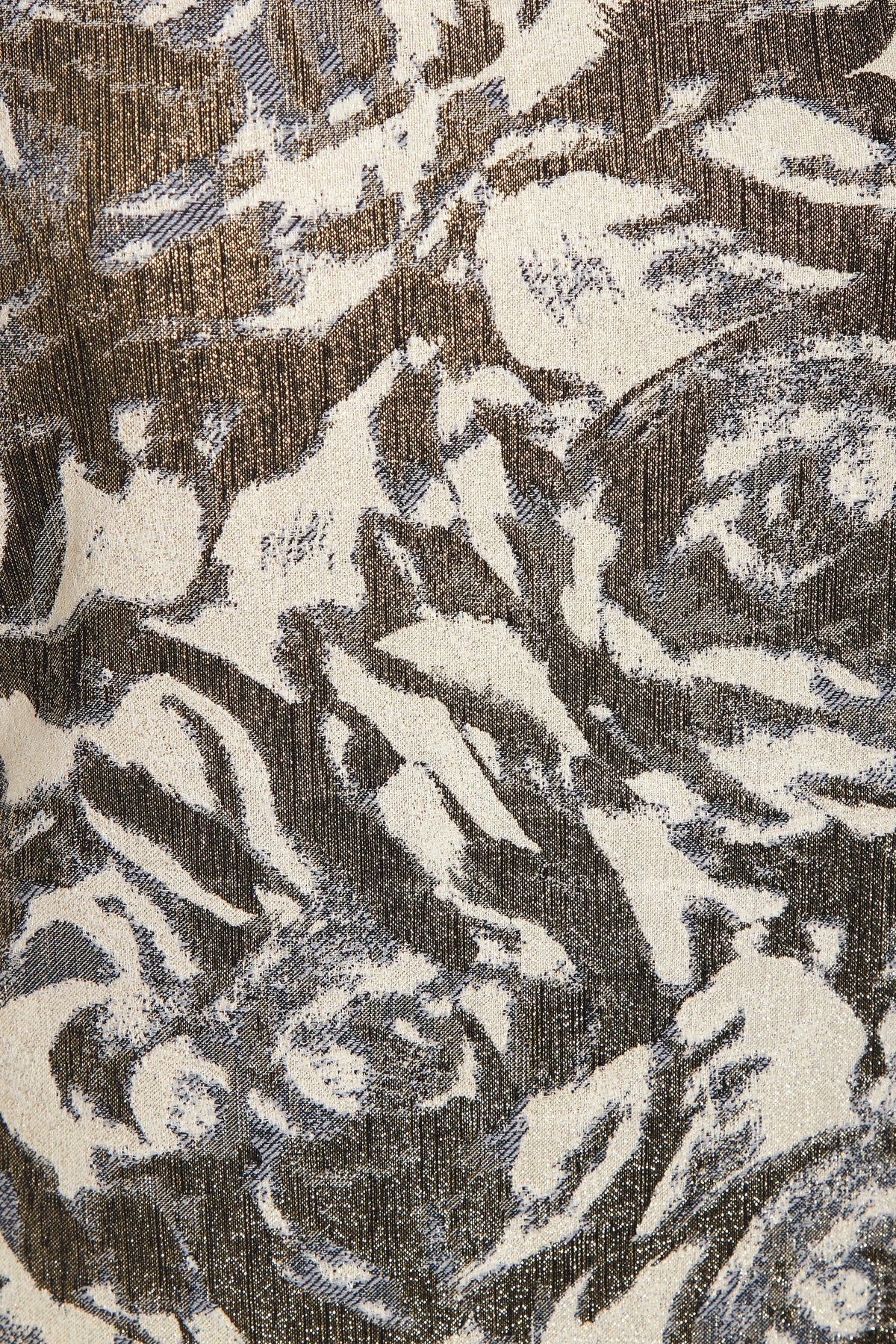 A close-up of Sarvin's Puff Shoulder Mini Dress shows its textured golden floral jacquard fabric with an abstract cream, brown, and gray pattern, slight sheen, and visible woven threads.