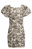 The Sarvin Puff Shoulder Mini Dress features puffed short sleeves, a golden floral jacquard swirl pattern in gold and silver on cream, a fitted silhouette, and a visible back seam.