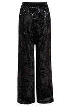 Sarvin’s Sequin Velvet Flared Trousers are black, handmade in the UK, and feature a relaxed fit with an elastic waistband. Covered in glossy sequins for a reflective look, they’re the perfect party piece.