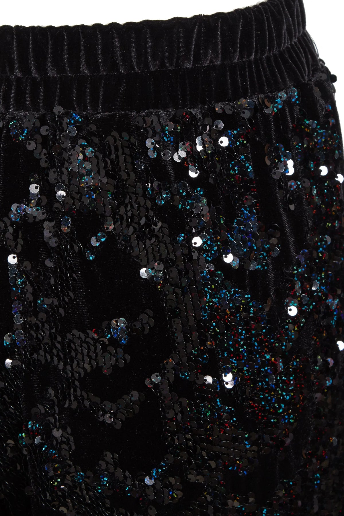 Close-up of Sarvin Sequin Velvet Flared Trousers: black velvet with an elastic waistband, embellished with shiny black and multicolored sequins in an abstract pattern—ideal for standout party wear. Handmade in the UK.