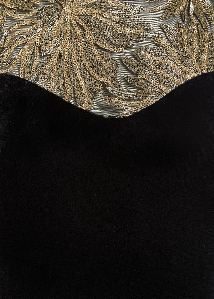 a black and gold Sweetheart Neckline Dress with embroidered leaves by Sarvin.