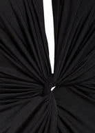 Close-up of black fabric gathered and twisted into a central knot, creating chic folds and draping—a stylish detail on the Sarvin Black Knot Front Midi Dress.