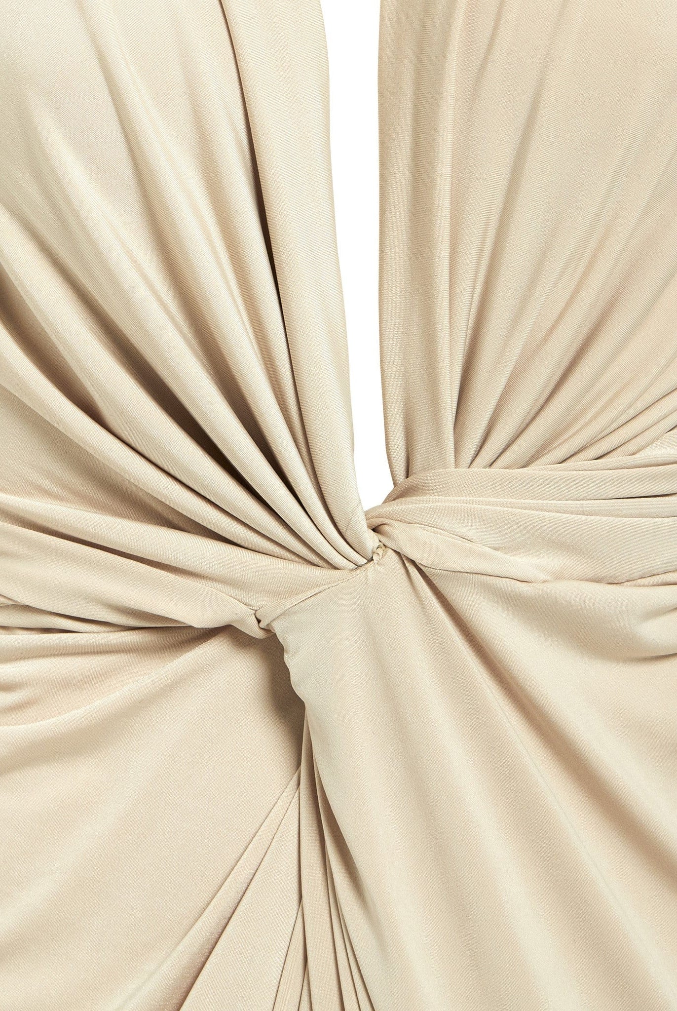 Close-up of smooth, slightly shiny beige fabric gathered and twisted at the center, creating soft folds—a detail featured in the Sarvin Low Cut Midi Dress.