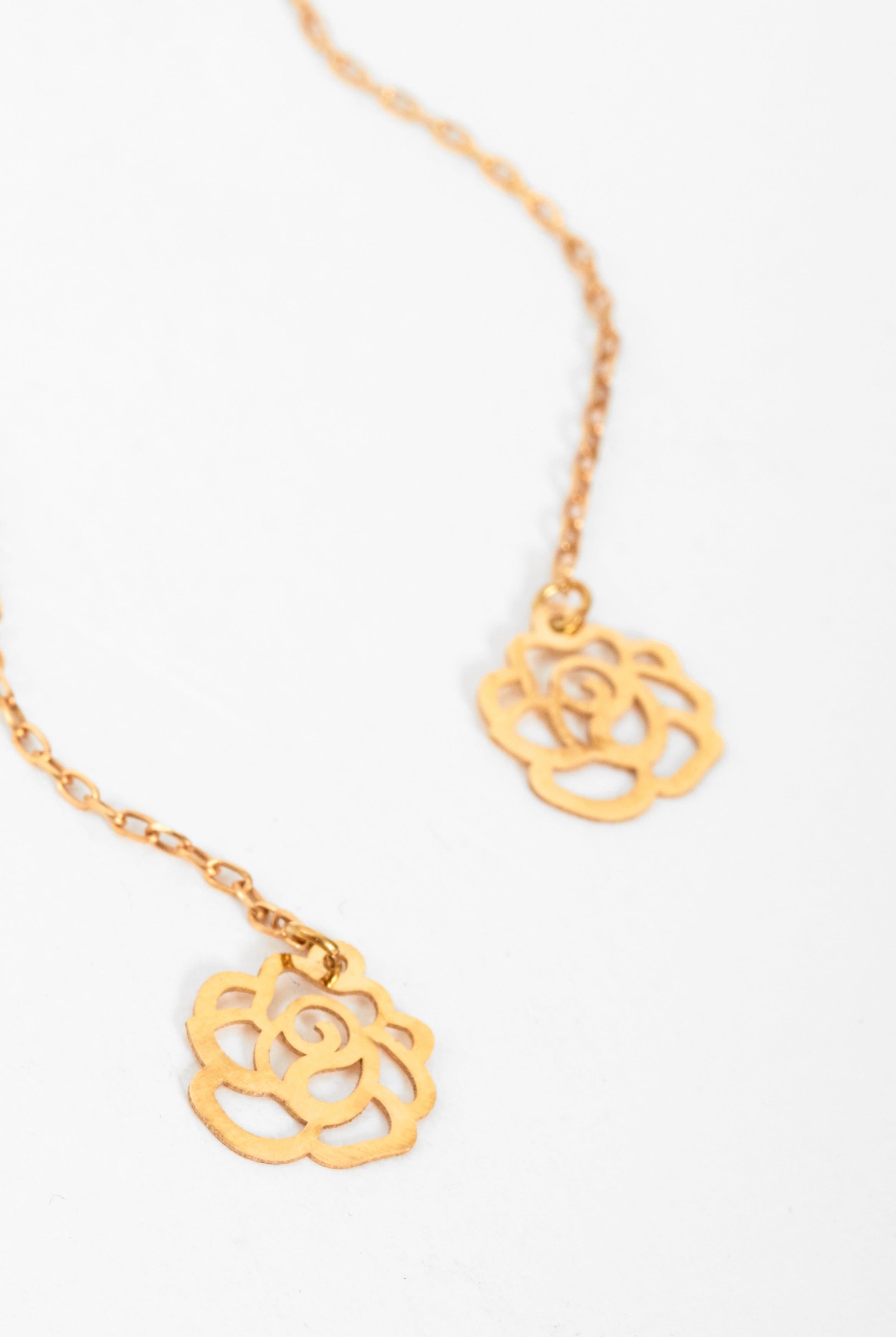 Sarvin's Flower Shape 18K Gold Drop Earrings, designed with rose-inspired shapes, are displayed elegantly on a white background.