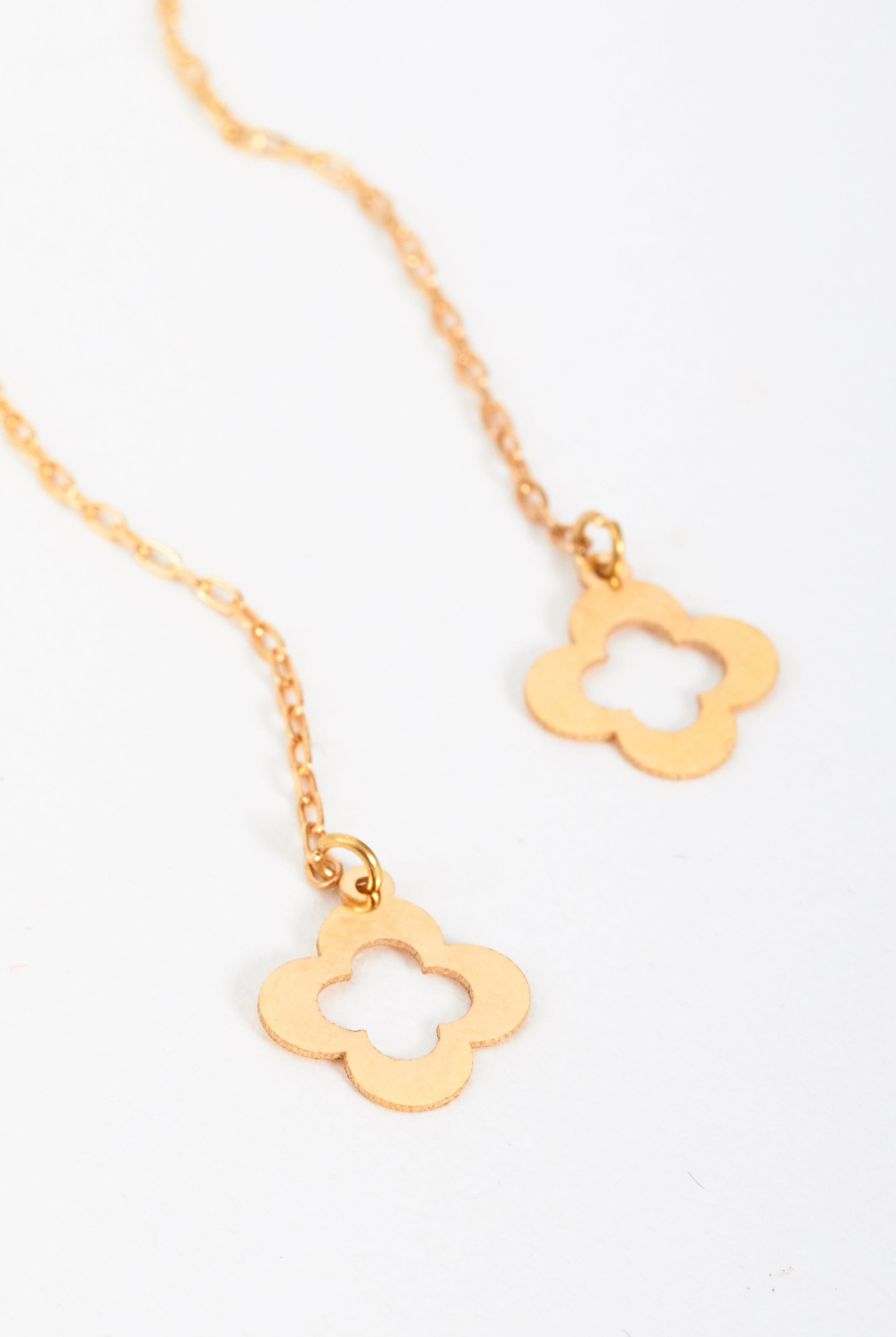 The Sarvin Clover Shape 18K Gold Threader Earrings feature two dangling, open-centered flower pendants on a gold chain, shown against a white background.