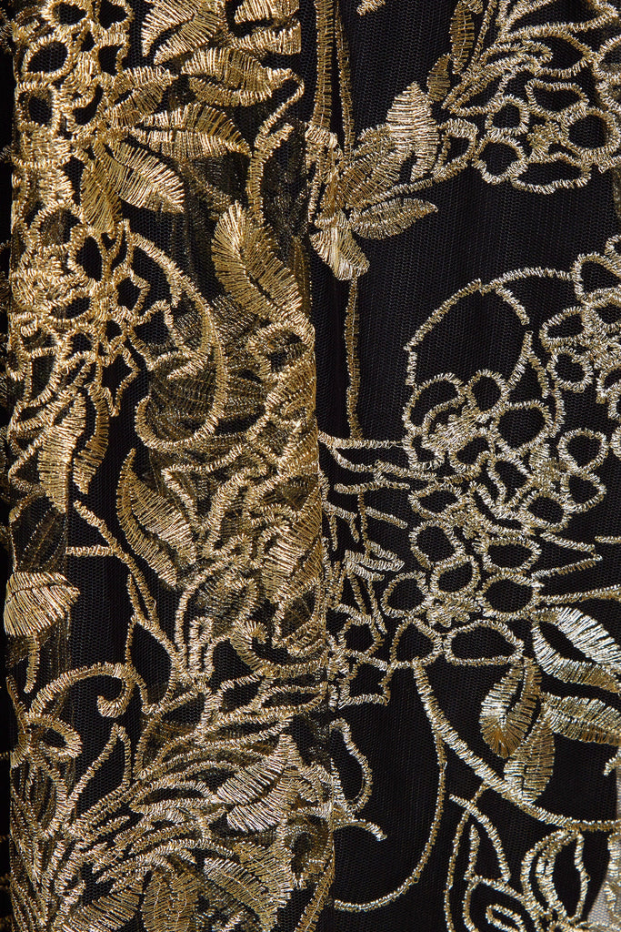 a close up of a Sarvin black and gold Embroidered Flutter Sleeve Dress.