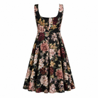 The Sarvin Golha Floral Corset Dress is a sleeveless, knee-length skater style featuring a fitted bodice and flared skirt, with a dark base and bold pink, burgundy, green, and beige floral print.