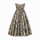 The Sarvin Tala Corset Midi Dress features a strapless, lace-up bodice and a full skirt in black and beige floral print, creating an elegant hourglass silhouette. Shown on a plain white background.