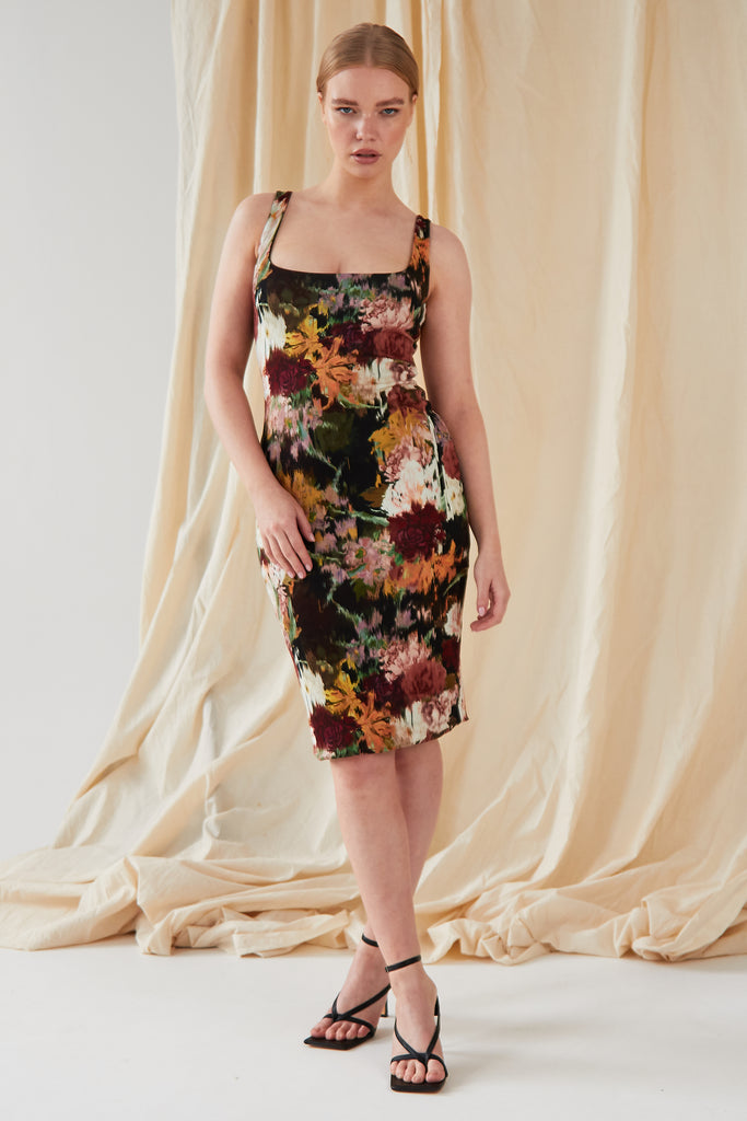 The model is wearing a Sarvin Sleeveless Floral Bodycon Dress.