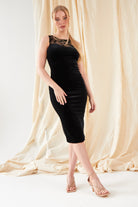 a woman wearing a Sarvin black Velvet Bodycon Dress.