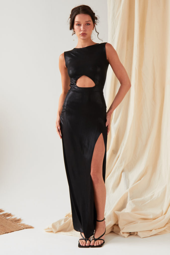 The model is wearing a Sarvin Black Cut Out Maxi Dress with a slit.
