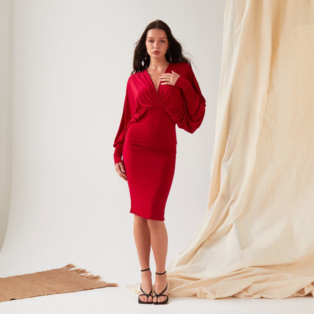 A Sarvin Red Batwing Dress model posing for a photo.