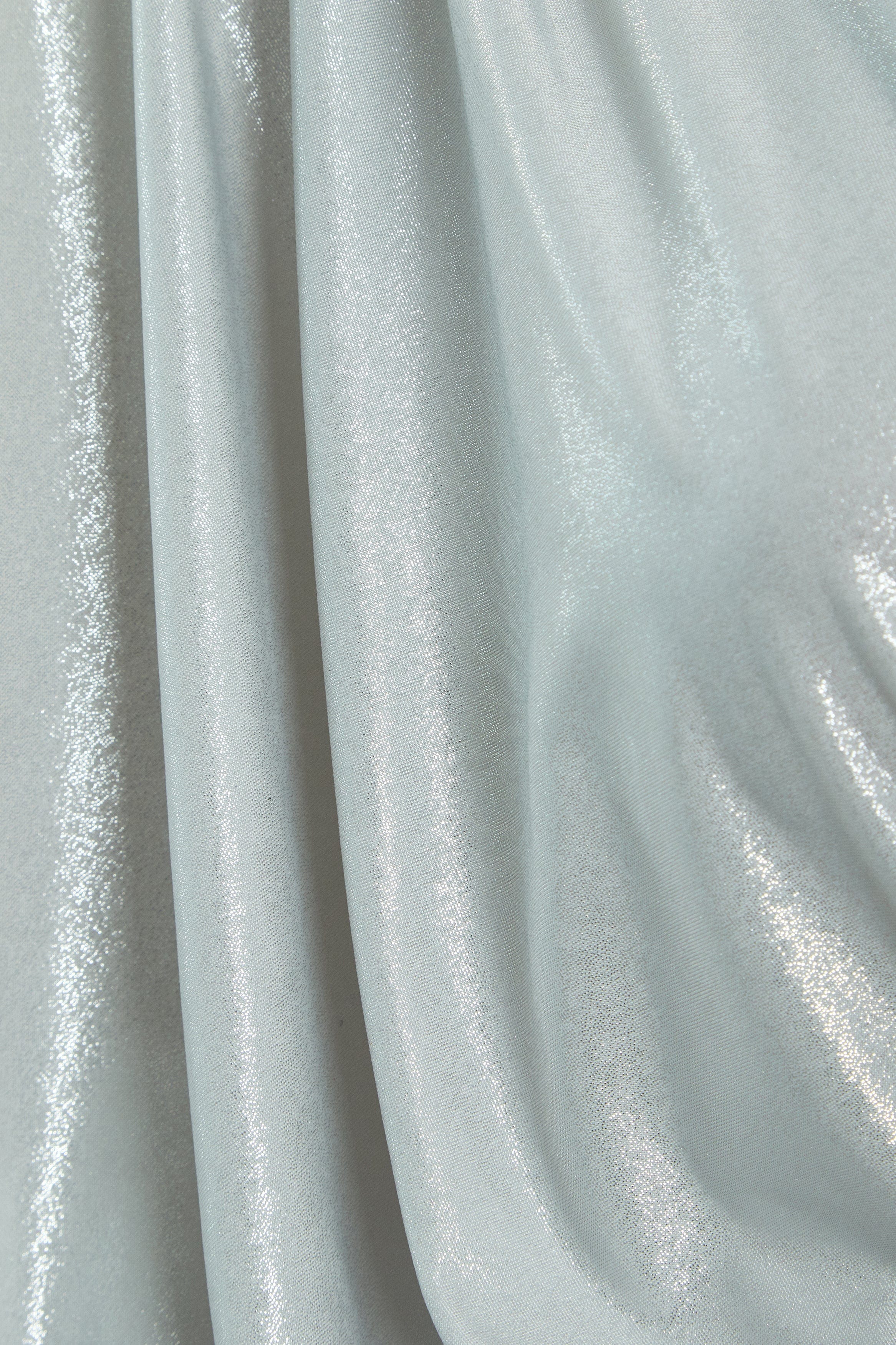 A close up of a Sarvin Batwing Sleeve Dress in light blue fabric.