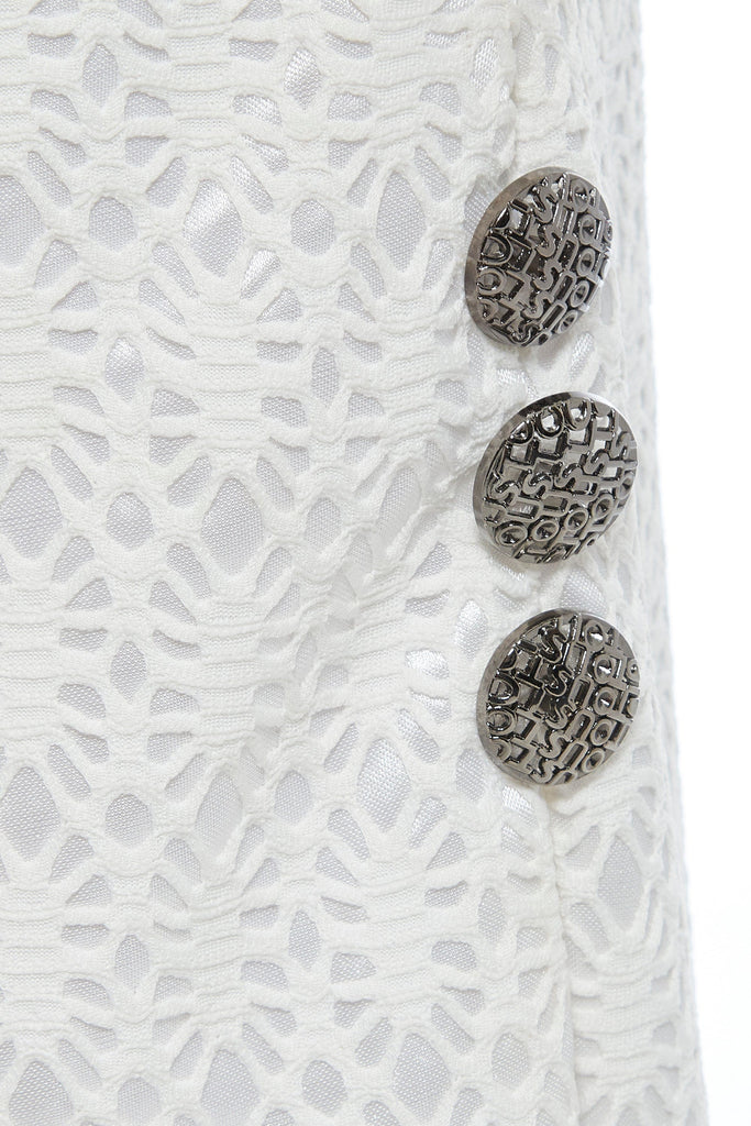 A close-up of a button on a Sarvin White Lace Bodycon Skirt.