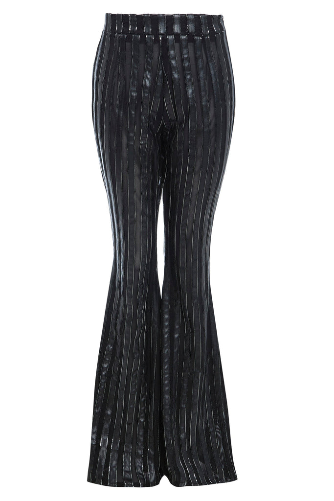 A woman's Sarvin black flared pants with a metallic striped pattern.