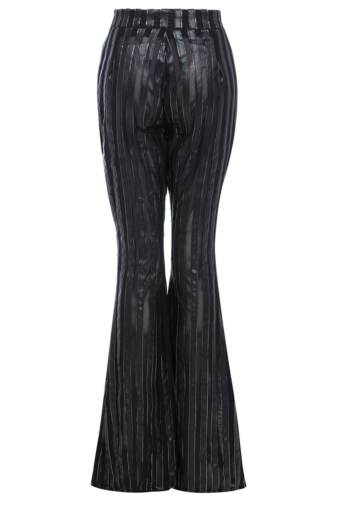 the back view of a woman wearing Sarvin's Flare Trousers In Metallic Stripe.