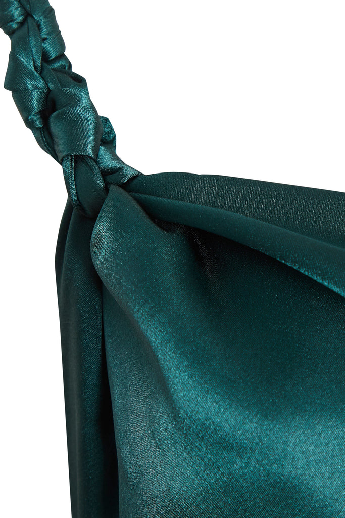 a close up of a teal Sarvin Backless Maxi Dress with a braided strap.
