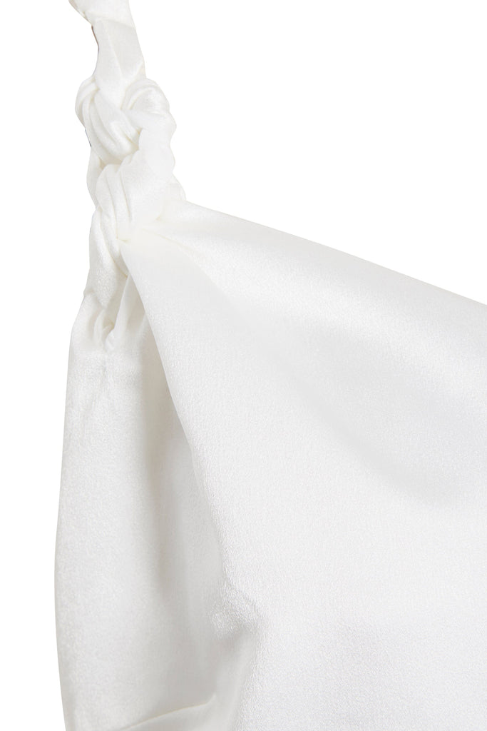 a close up of an Asymmetric White Maxi Dress by Sarvin with a knot on it.