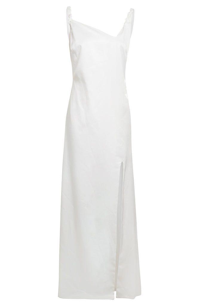 An Asymmetric White Maxi Dress by Sarvin with a slit on the side.