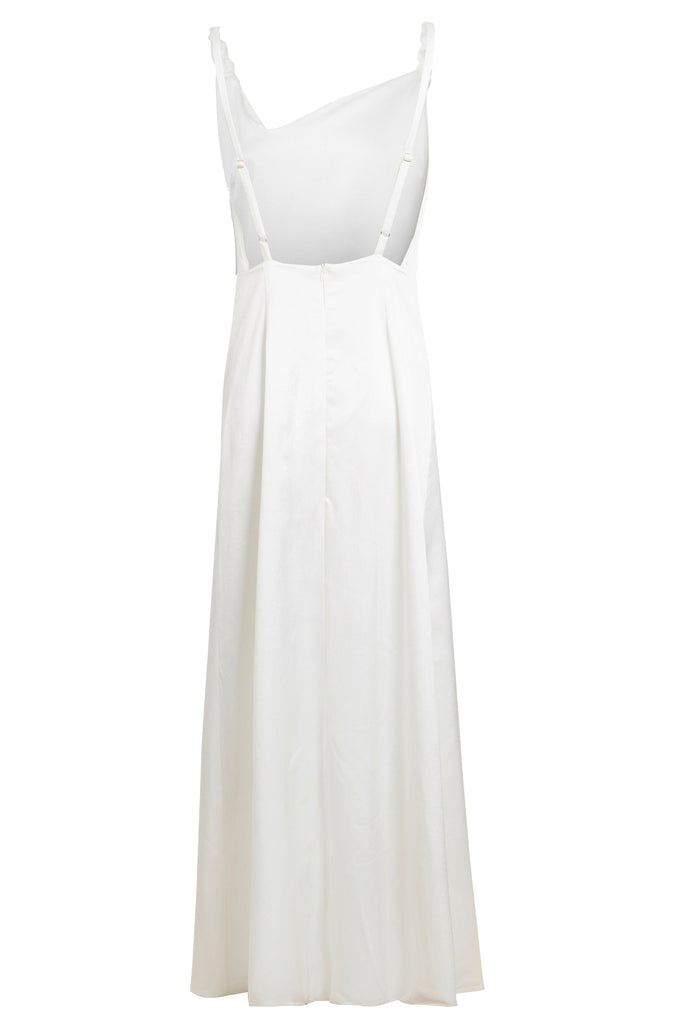 An Asymmetric White Maxi Dress by Sarvin with straps and buttons.