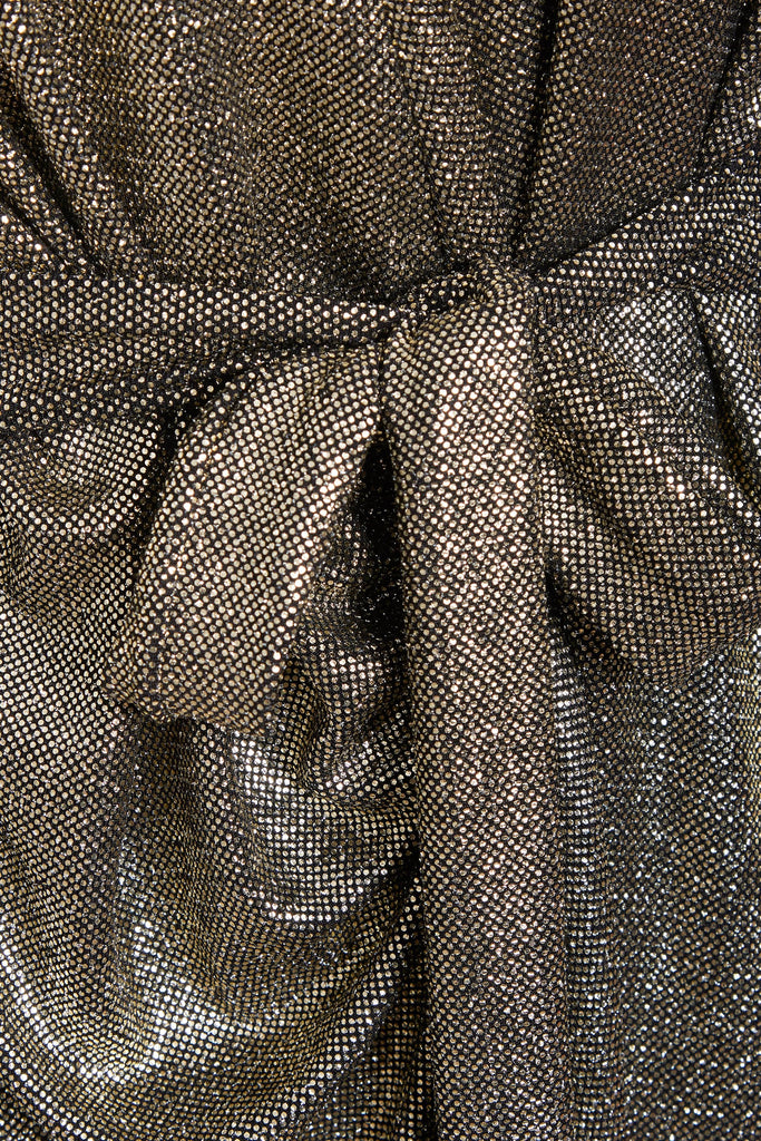 a close up of a Sarvin Sequin Wrap Dress with a belt.